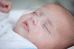 Close up photo of cute sleeping newborn baby, face