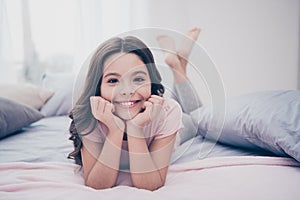 Close up photo cute sweet beautiful she her little girl crossed legs lying down pillow hands arms hold head homey sunday