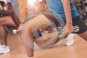 Close-up photo of dad and son in the same clothes in gym. Father and son lead a healthy lifestyle.