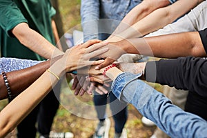 Close-up photo of diverse people`s hands gathered together