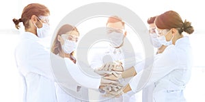 Close-up Photo Of Doctors Stacking Hand With Coworkers