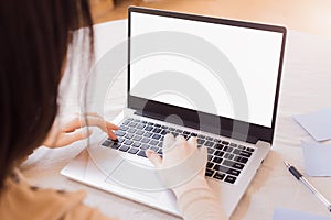 Close up photo of female hands and laptop with blank monitor. Mockup of computer screen. Copy Space ready for design or text