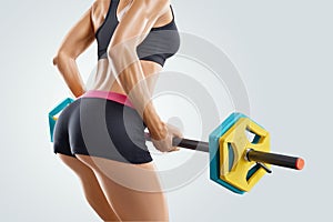 Close up photo of fitness woman workout with barbell at gym