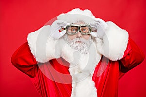 Close up photo of focused funky cool santa claus fix his goggles before rocket flight wear white gloves cap