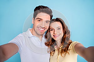 Close up photo of foxy lady brunet guy pair making selfies toothy beaming smile wear casual t-shirts isolated blue