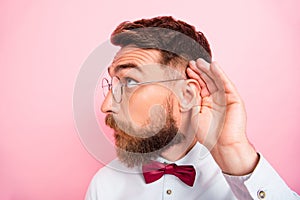 Close-up photo of funny funky smart concentrated hipster gentleman holding palm near ear catching familiar sound