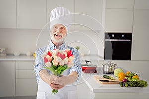 Close up photo funny grey haired he his him grandpa hands arms holding flowers meet ladies 8 march wear chefs white