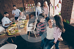 Close up photo of gathered relatives in decorated home house din