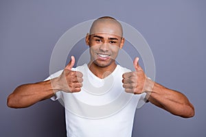 Close up photo glad healthy teeth dark skin he him his macho bald head sure approve show thumbs fingers up advise buy