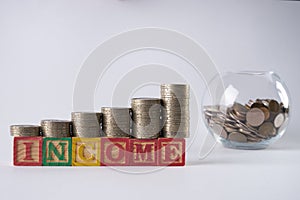 Close-up photo with golden coins in Piggy bank.Income increase concept with upward pile of coins