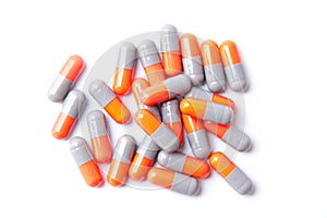 Close-up photo of Gray orange pills isolated on white background