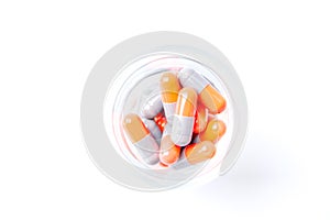 Close-up photo of Gray orange pills isolated on white background