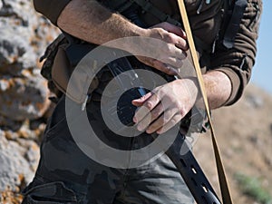 Close up photo of hands of commando with sniper rifle.