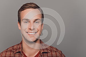 Close up photo of happy young man with beaming smile