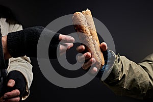close-up photo of homeless people& x27;s hands sharing food