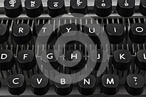 Close-up photo of keyboard and keys with letters of an old and vintage typewriter, side view