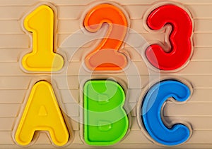 Close up photo of kids toy multi colored numbers and letters