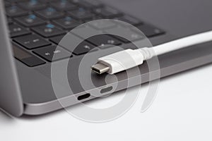 Close-up photo of a laptop type-c ports and type-c cable photo