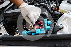 Close up photo of male checking parts of automobile