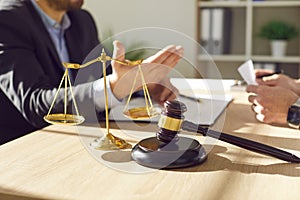 Close up of photo of a male lawyer working on his workplace in office on a wooden table.