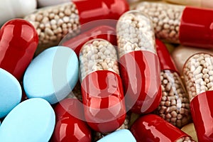 Close-up photo of many red, yellow and blue pills