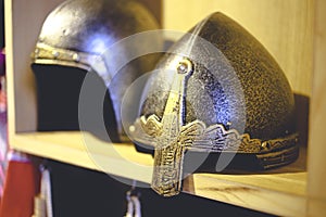 Close-up photo of medieval helmet , ancient warrior iron knight shining style . Concept of old vintage traditions , extreme fight