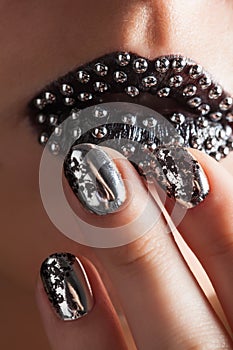 Close-up photo of metallic lips and Minx nails