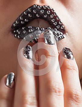 Close-up photo of metallic lips and Minx nails