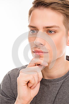 Close up photo of minded man touching his chin
