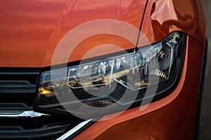 Close up photo of modern and clean car, detail of headlight. Headlight car Projector/LED of a modern luxury technology and auto
