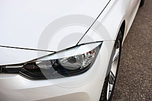 Close up photo of modern and clean car, detail of headlight. Headlight car Projector/LED of a modern luxury technology and auto