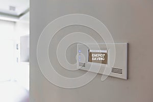 Close up photo of modern energy saving touch switch board on wall