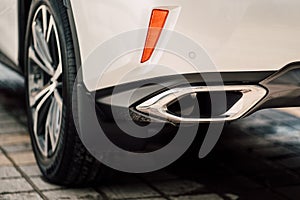 Close up photo of modern luxury sport car suv elegant design mufflers tailpipe. photo