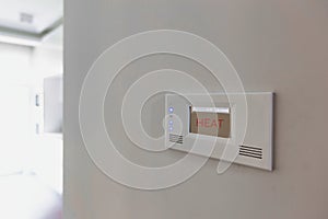 Close up photo of modern temperature touch switch board on wall