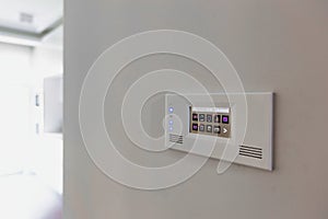 Close up photo of modern touch switch board on wall