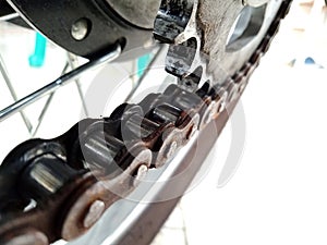 Close-up photo of a motorbike chain and gears