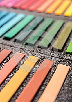 Close-up photo of new colorful chalk pastels in box