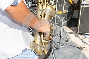 Close up photo of outdoors musician playing saxophone at jazz festival