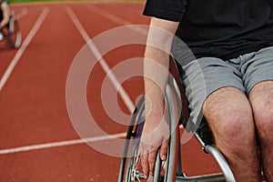 Close up photo of a person with disability in a wheelchair training tirelessly on the track in preparation for the