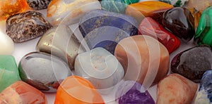 Close-up photo of polished gemstones. High-angle view. Colorful gemstones background.