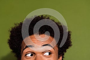 Close up photo portrait of attractive young man eyes look interested empty space isolated on khaki color background