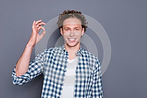 Close up photo portrait ofsatisfied cool handsome guy making ok symbol grey background