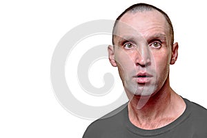 A close-up photo, a portrait of a surprised adult man with his mouth slightly open on a white background.