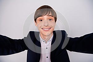 Close up photo of positive cheerful boy have fun free time rest relax make photo blogger video call live isolated wear