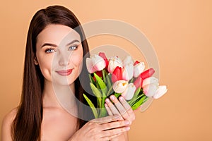 Close up photo of positive cheerful girl enjoy present for 8-march hold flowers given after colage beauty spa salon