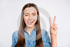 Close up photo of positive cheerful girl have fun lick lips wink blink make v-signs wear casual style clothing isolated
