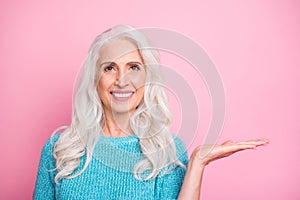 Close up photo of positive cheerful old woman hold hand present adverts promo demonstrate her choice decisions wear good