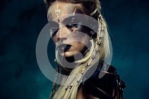 Close up photo of powerful viking queen princess with scar experienced fighter in north war over dark background