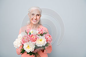 Close up photo of pretty cute sweet kind friendly sincere lady holding nice flowers in hands isolated grey background