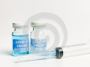 Close up photo rejected and torn label covid 19 vaccine doses with syringe. photo